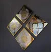 Four decorative plates with intricate designs on a dark background